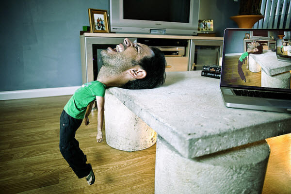 A man struggling with back pain due to a large head