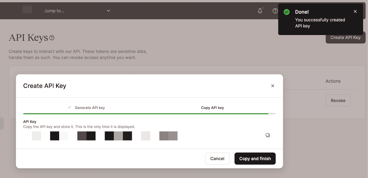 The "Create API Key" dialog box displays the newly generated API key, which is blurred out for security. There are options to Copy the API key or Revoke it. A success message at the top confirms that the API key was successfully created.