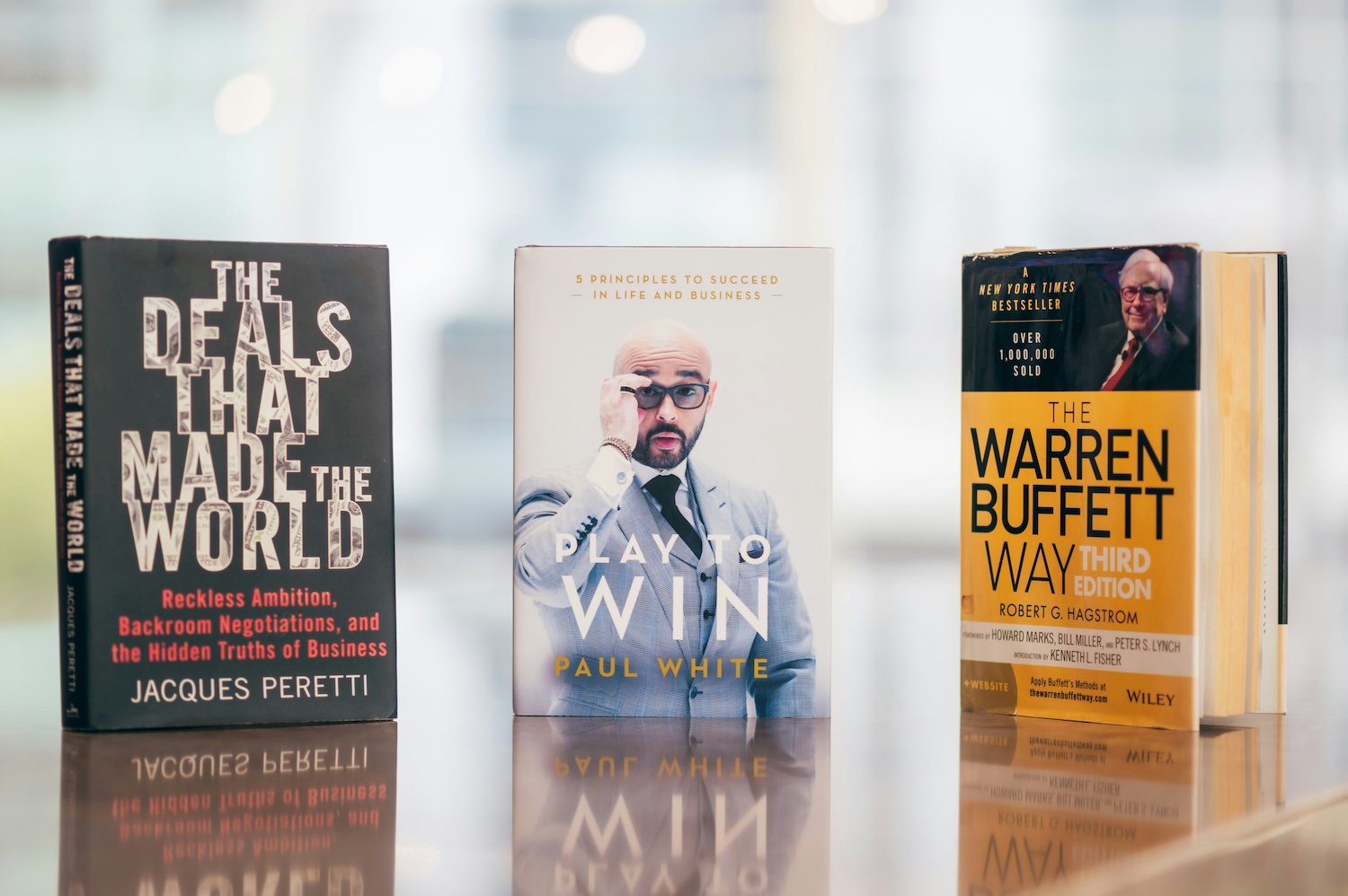 stack of economics books on a desk