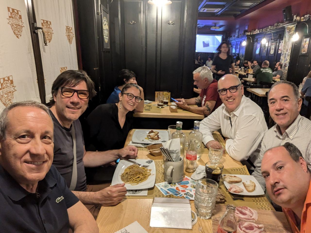 group of people sitting at table eating